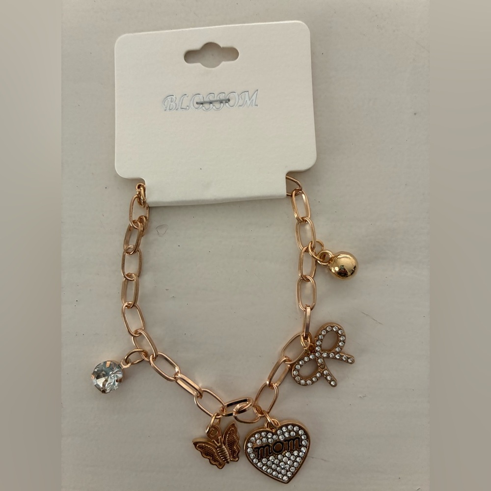 NWT Gold “Mom” Charm Bracelet with other designs. Brand new.